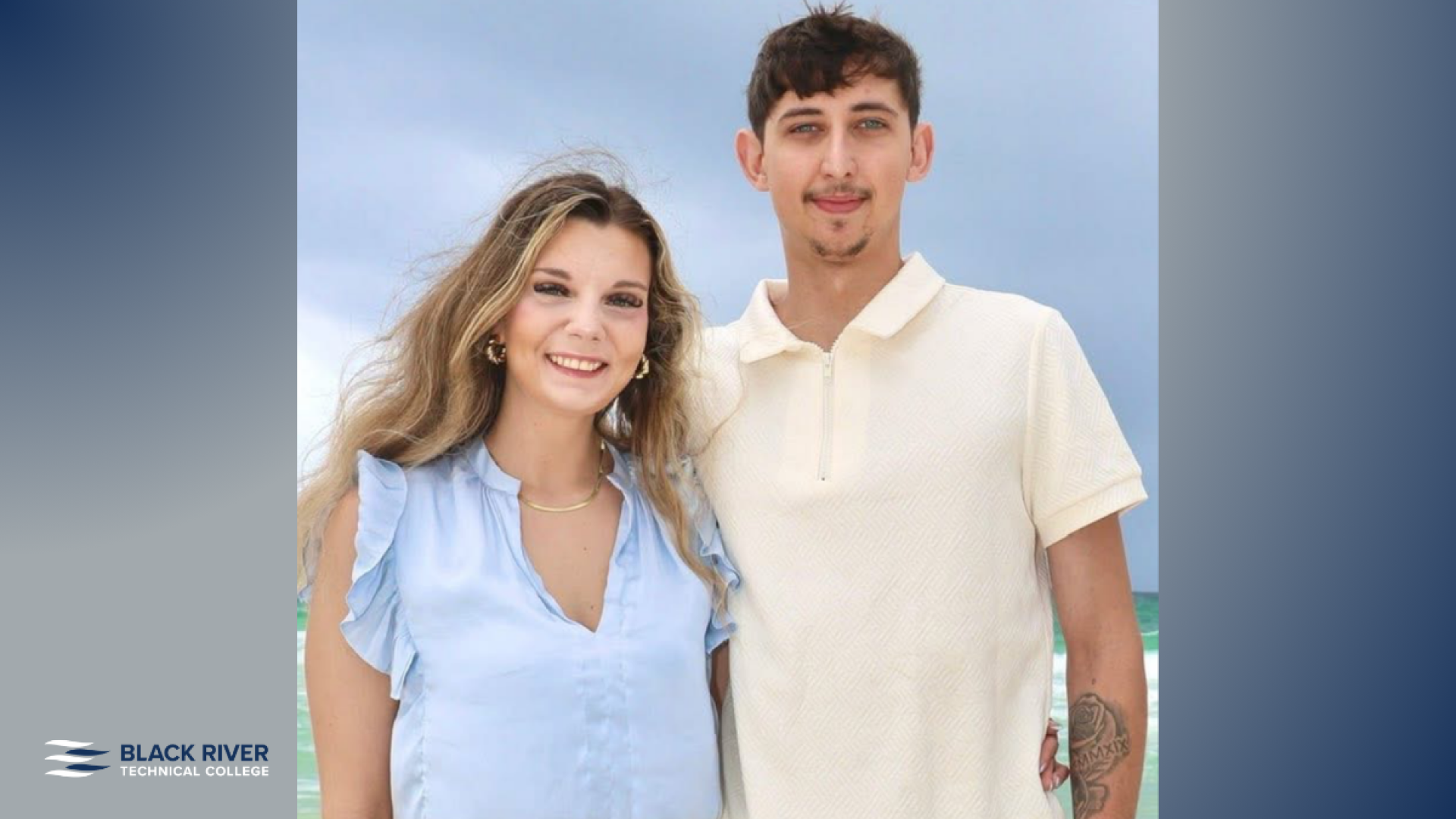 A young woman in a light blue blouse and a young man in a cream polo shirt smile together on a beach, with Black River Technical College branding.